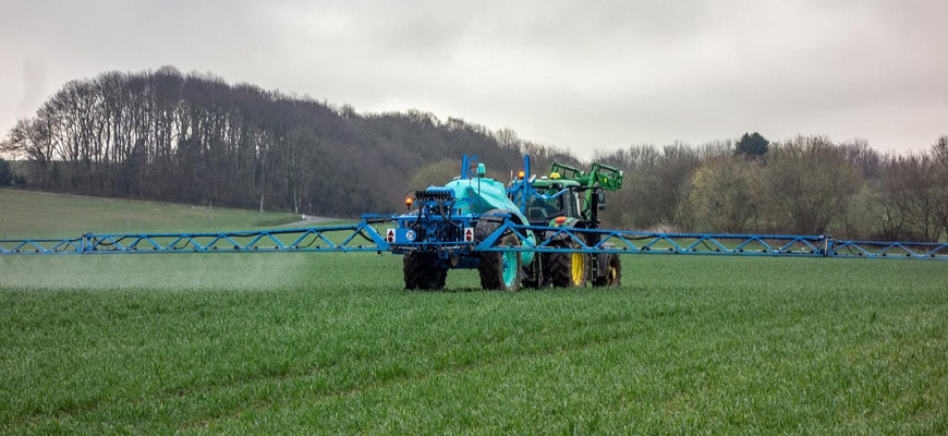 Tractor fertilizing a large commercial property.