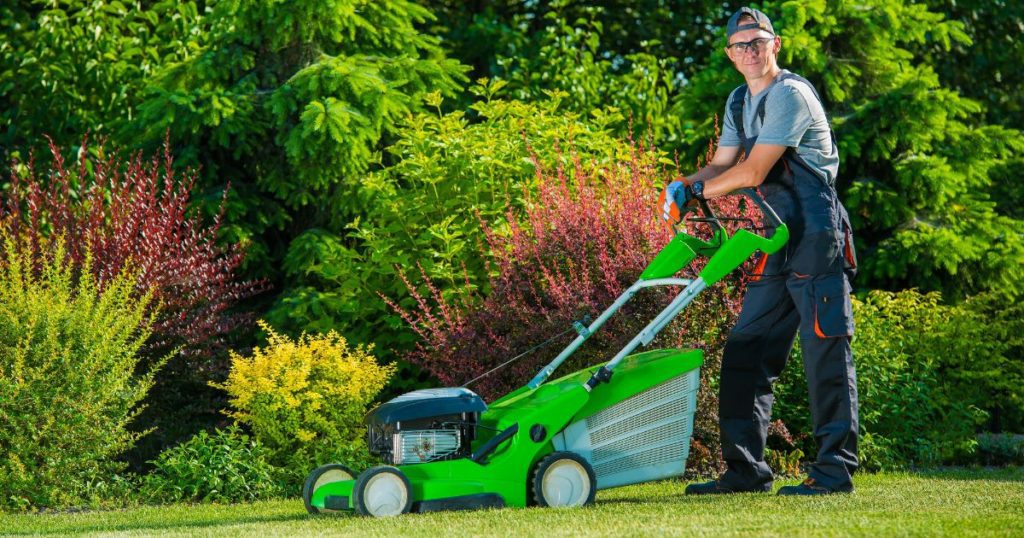 Landscaper mowing lawn